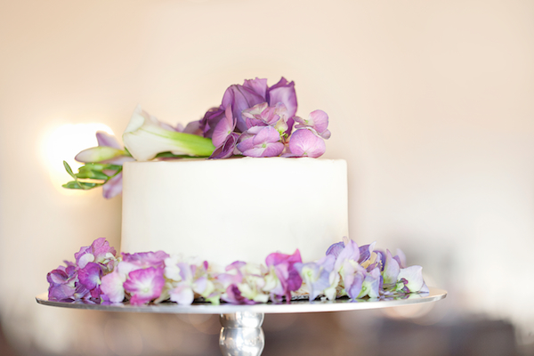 wedding cake with purple flowers
